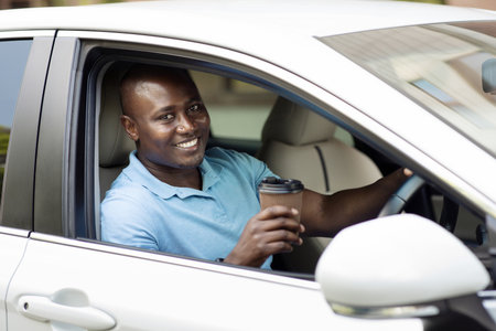Smiling african american man driver drinking coffee