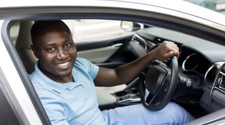Smiling african american man sitting in auto