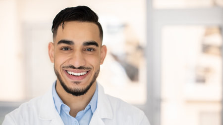 Closeup Portrait Of Smiling Young Middle Eastern Therapist Doctor In Uniformの写真素材