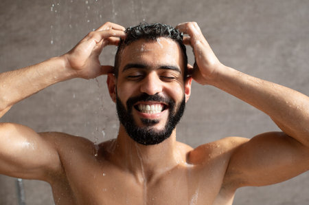 Young Arabic Male Model Enjoys Morning Shower, Applying Shampoo With Joy and Care