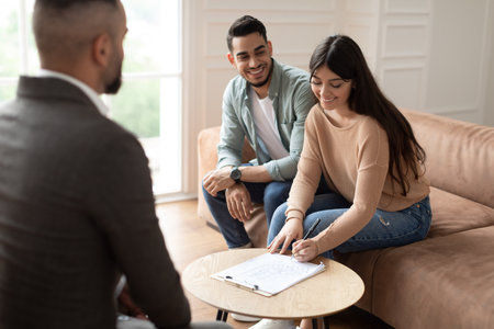 Real Estate Agent Showing Buyers Contract, Woman Signingの写真素材