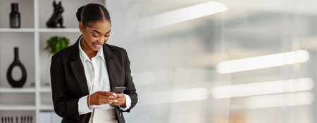 Business Meeting Preparation by a Professional Woman Using Her Smartphone in a Modern Office Settingの写真素材