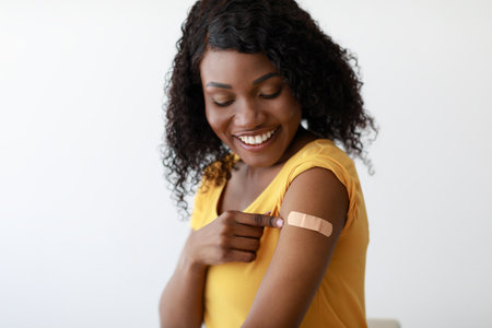 Covid-19 Vaccinated Black Woman Showing Arm After Vaccine Injection, Studio