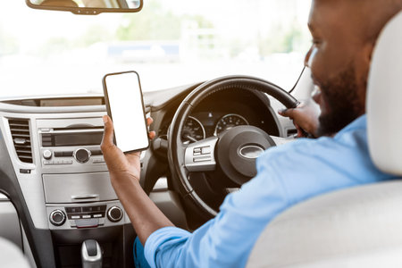 Happy black guy using showing smartphone with empty screen