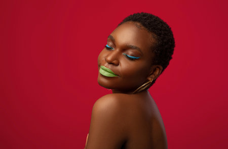 Closeup portrait of young black woman on redの写真素材