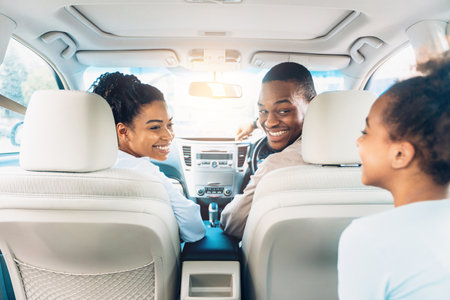Happy Black Family Of Three Enjoying Car Ride During Summerの写真素材