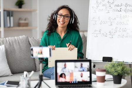 Female teacher giving online lecture to students recording video