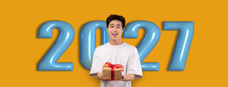 Celebration of a Special Occasion With a Young Person Holding a Gift in a Bright Backgroundの写真素材