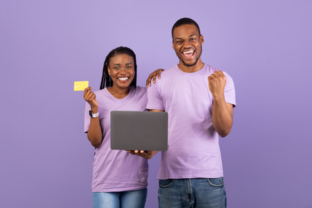 Black family using computer and gesturing yesの写真素材