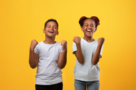 Emotional brother and sister showing yes gestureの写真素材