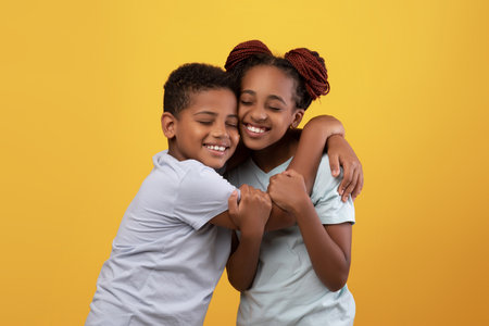 Loving kid brother hugging his cute older sister