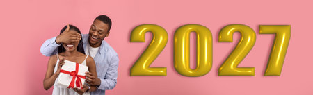 Couple Celebrates New Years Eve With Gifts and Joy for the Year 2027の写真素材