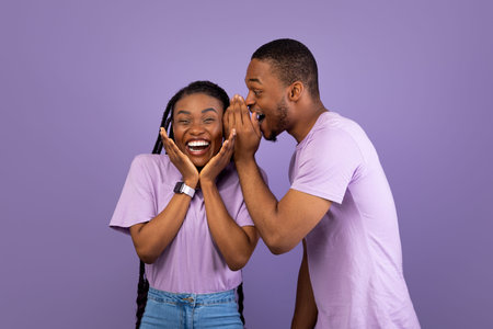 Black Man Sharing News With His Excited Girlfriend Whispering To Ear