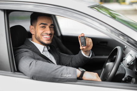 Handsome arabic businessman holding automatic car key
