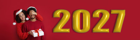 People Celebrate a New Year in a Festive Collage With Red Background and Gold Numbersの写真素材