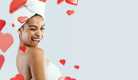 Portrait of Black Spa Girl Having Fun While Blinking at the Camera With Heart Decorationsの写真素材