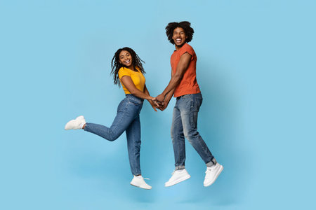 Romantic black loving couple posing over blueの写真素材