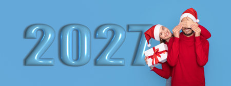 Festive Collage Celebrating New Year With a Joyful Couple and Holiday Elements in 2027の写真素材