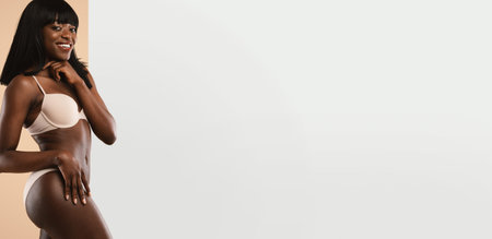 Woman Poses for a Beauty Set in a Studio With Neutral Background and Soft Lightingの写真素材