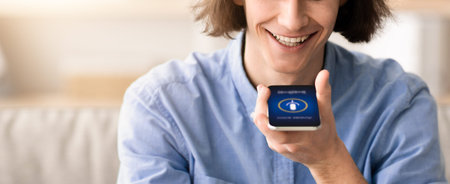 Young Man Using Smartphone for Voice Commands at Home During Daytime