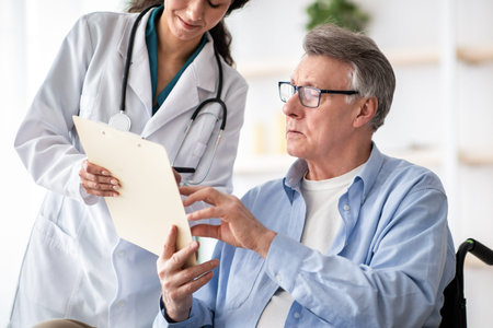 Doctor and Patient Discussing Health Information in a Modern Clinicの写真素材