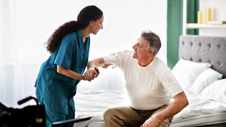 Healthcare Worker Assists Older Man in His Bedroom During Care Session at Homeの写真素材