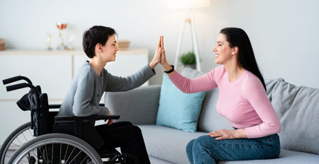 Mother and Son Share a Joyful Moment at Home While Playing a Hand Gameの写真素材