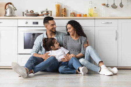 Cheerful loving arab family spending weekend together at homeの写真素材