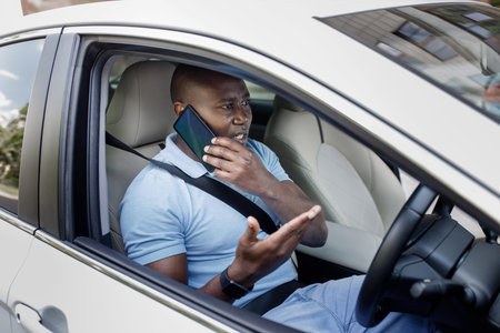 Man having phone conversation while driving car