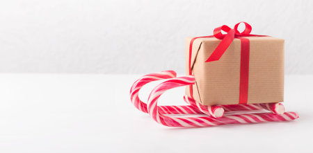 Creative winter sleigh of gift box and candy canesの写真素材