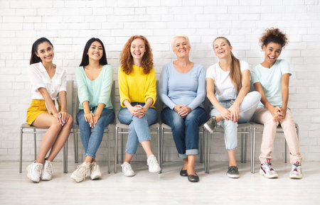Ladies Of Different Age Sitting On Chairs Indoorの写真素材