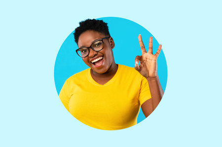 Happy Person Showing Hand Sign in Bright Yellow Shirt With Blue Background