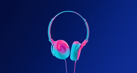 New modern device in neon. Headphones with wires on blue backgroundの写真素材