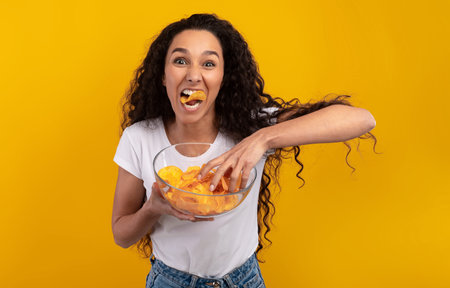 Excited Latin Lady Eating Delicious Potato Crisps
