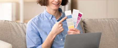 Person Selecting Paint Colors Indoors While Sitting on a Couch With a Laptop