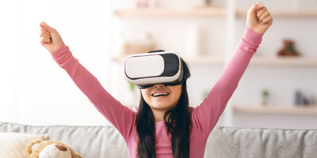 Girl Plays Virtual Reality Game at Home With Excitement and Joy During Afternoonの写真素材