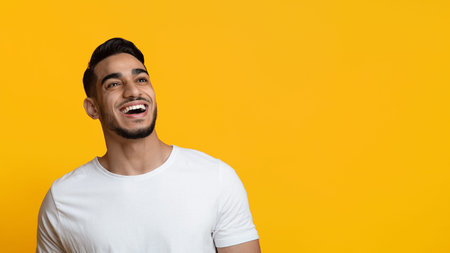 Closeup portrait of cheerful arabic guy looking at copy spaceの写真素材