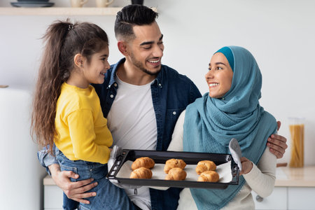 Baking Together. Happy Arab Family Of Three Holding Tray With Homemade Croissantsの写真素材