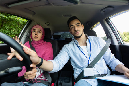 Nervous Muslim Lady In Hijab Having Driving Lesson With Instructor