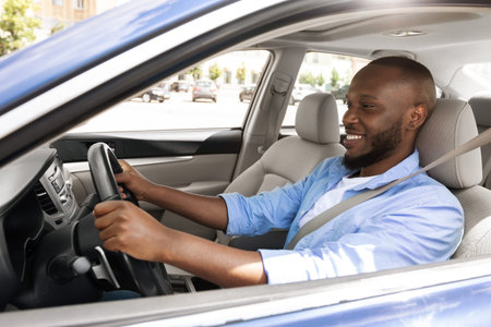 Smiling guy driving new car in city