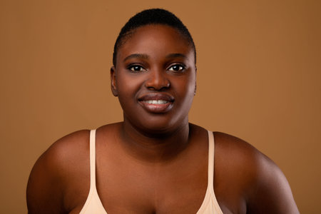 Beautiful plus size African american woman posing at cameraの写真素材
