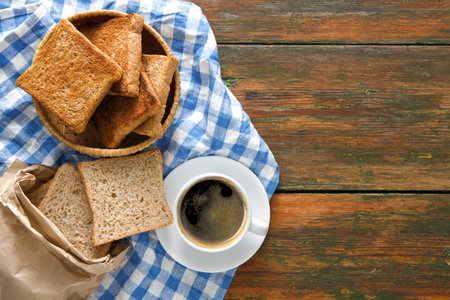 Breakfast background, toast and coffee on rustic wood, top view