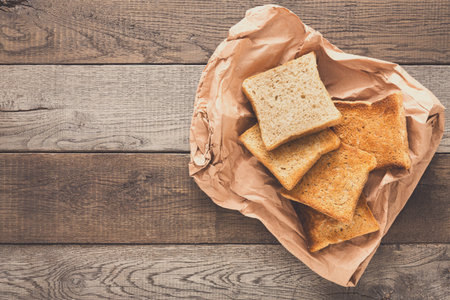 White bread toasts on rustic wood background