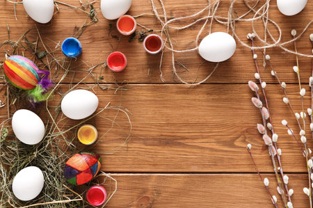 Colorful Easter Egg Decorating Setup With Paint and Natural Decorations