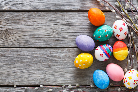 Colorful Decorated Eggs on Wooden Surface With Spring Elements for Easter Celebration
