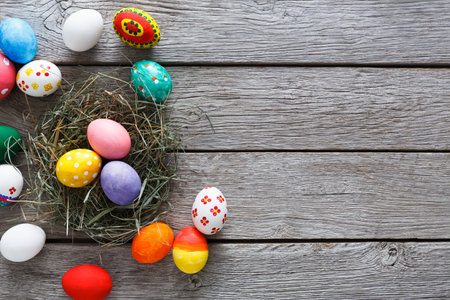 Colorful Decorated Eggs Arranged in a Nest on Wooden Table for Spring Celebration