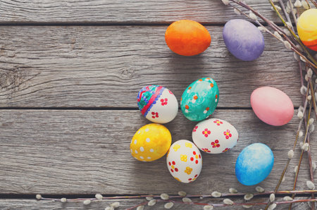Colorful Easter Eggs Arranged on a Rustic Wooden Table With Decorative Branches