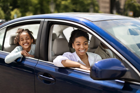 African American Family Posing Sitting In Blue Car
