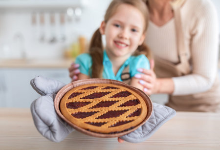 Happy senior woman and her granddaughter showing jam pieの写真素材