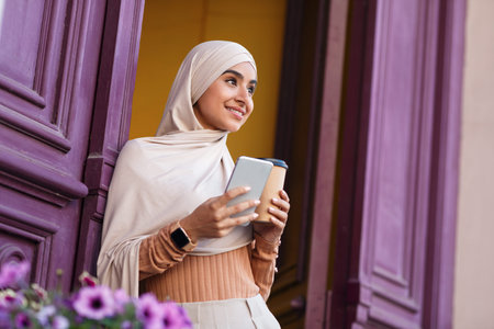 Good morning coffee on way to work, satisfied facial expression, enjoy outdoorの写真素材